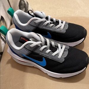 Nike Kids Black and Gray Sneakers with Blue Accents